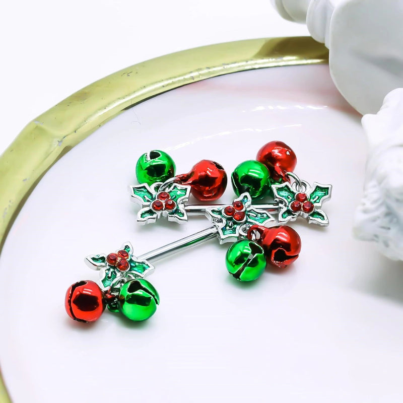  Two shiny silver nipple barbells with dangling Christmas jingle bells on a festive red background.